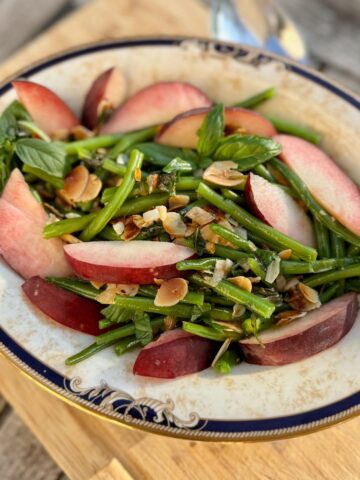 french green beans sauteed in a salad with a fresh peach